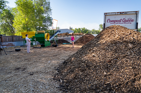 pile of compost mulch near large truck