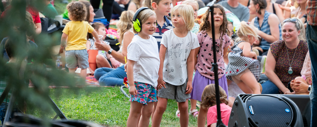 children and families in large crowd at outdoor concert