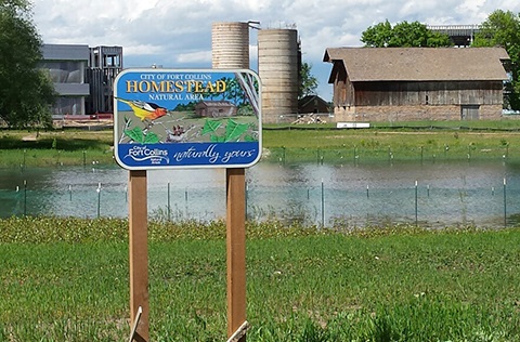 Wooden sign for Homestead Natural Area.