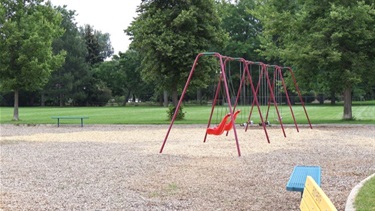 A swing set in a playground area