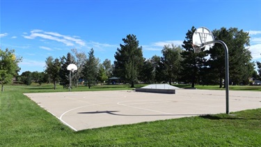 A paved basketball court with two hoops