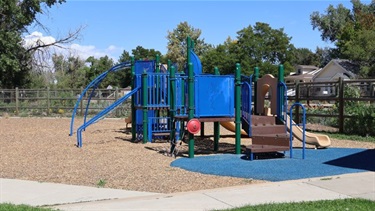 A bright blue playground structure at a park