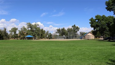 A ball field at a park on a sunny day