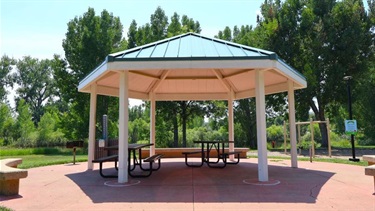 A sheltered park pavilion with picnic tables
