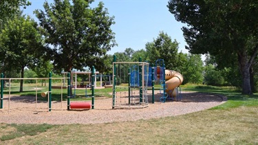A park playground surrounded by trees
