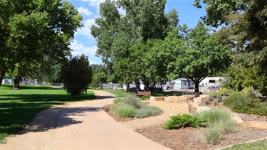 A sidewalk running through a park