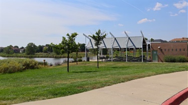 A pavilion next to a lake on a sunny day