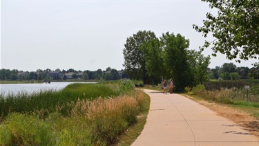 A paved trail alongside a lake