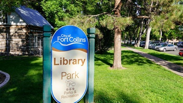 A Library Park sign in front of a park