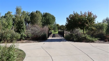 Pavement leading to a bridge over a creek