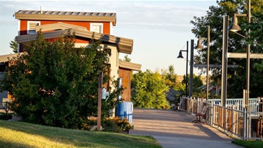 A sidewalk running past a building at a park