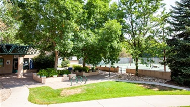 A tennis facility with courts, benches and a pro shop building