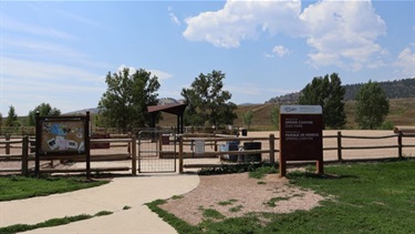 A dog park enclosed by a wooden fence