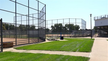 Two ball fields next to a sidewalk