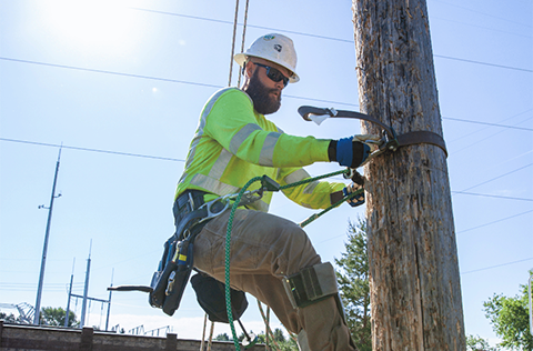 lineworker climbing utility pole