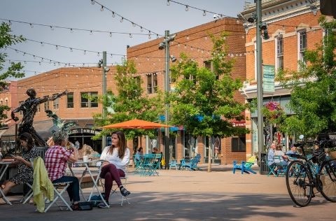 Two people sitting at a small table in Old Town Square.