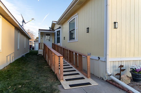 A photo of a ramp leading into a mobile home.