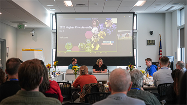 leaders present with slides in crowded room