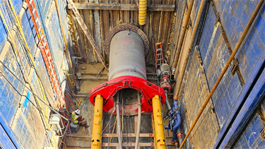 aerial of large pipe inset below street