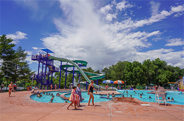 Family walks beside vibrant public pool