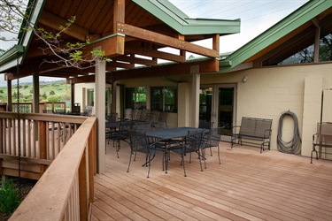 Large deck with lake views including covered areas.