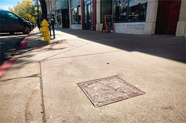 sidewalk with embedded granite paver with art