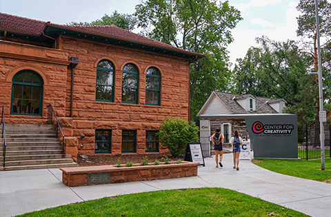 red brick building with people entering through the side