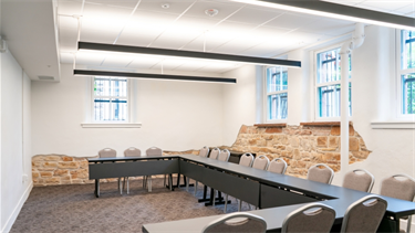medium room with exposed brick walls and tables and chairs