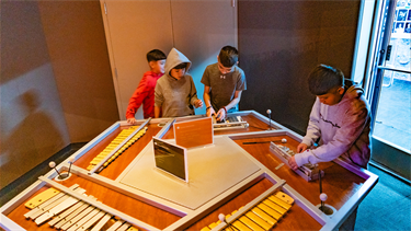 children play with interaction museum exhibit on table