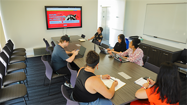 people in work meeting at table